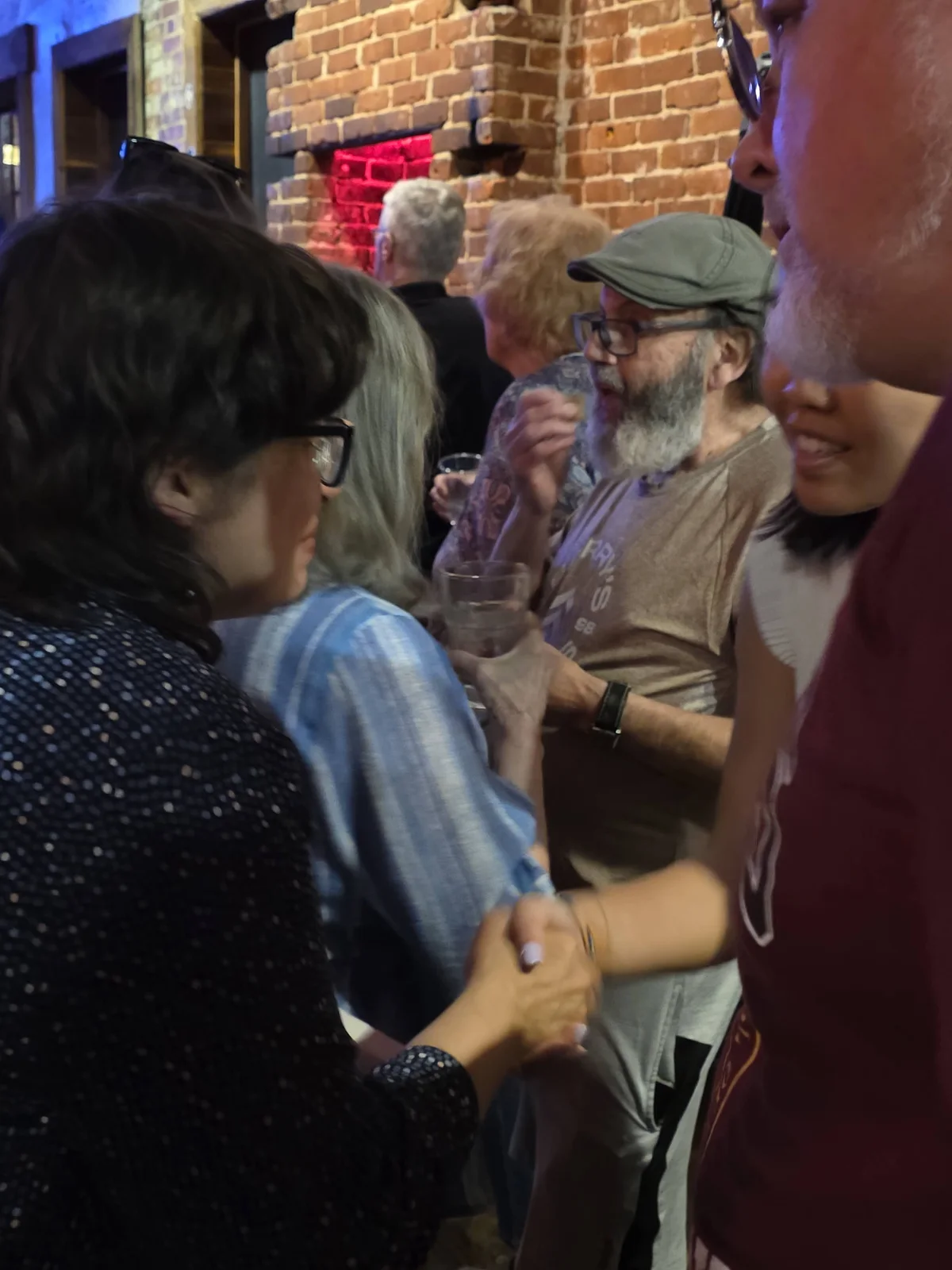 Rachel Fetty Anderson greets a supporter at a community gathering.